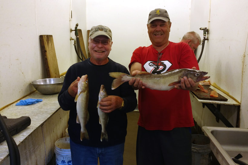 fishermen in the fish cleaning room at Northland Lodge