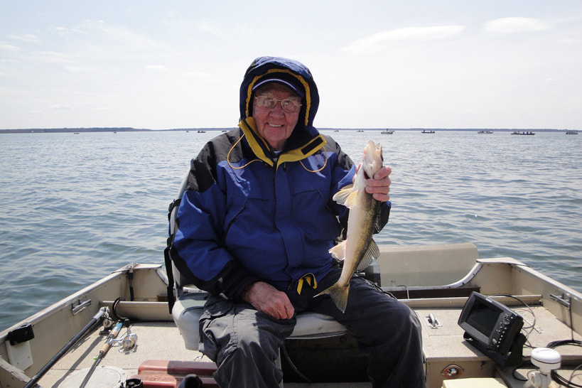 fisherman with his walleye caught on Lake Winnine in the fall